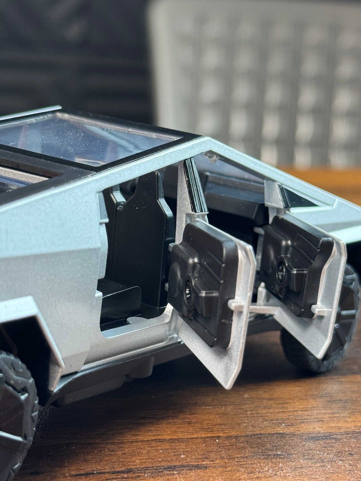 Model of a vehicle with open doors on a wooden surface